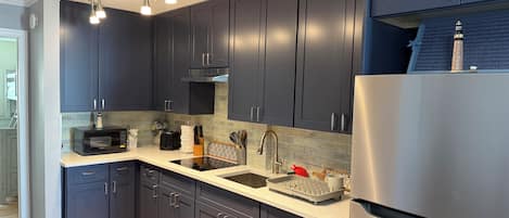 Fridge, microwave, stovetop, coffee/tea maker