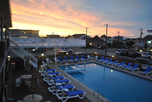 Relax by the pool surrounded by comfortable lounge chairs and enjoy the serene atmosphere.