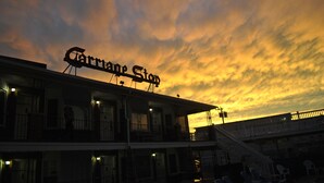A building with a sign reading "Carnival Stop" against a sunset sky. - Your Summer Escape Awaits!!!  Walking distance to the pristine WWC beaches!!! (Wildwood Crest)