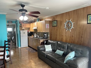 Cozy living space with a kitchenette, sofa, and dining area.