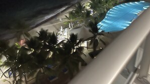 A resort with a pool, palm trees, and a beach. - Ocean Front In Marbella Assigned underground Parking & fast internet 150 Mbps  (Juan Dolio)
