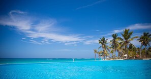 An infinity pool - Modern & Stylish 2 Bedroom Pool View  Apartment at Cana Rock (Punta Cana)