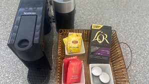 A Nespresso coffee machine, a basket with Lipton tea, and a box of L'Or espresso.