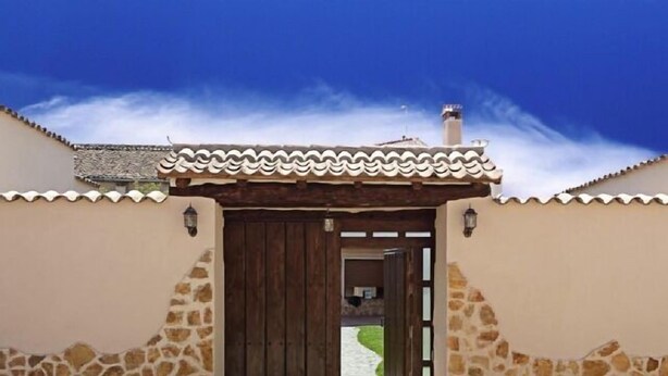 A traditional building with a tiled roof, a wooden door, and stone walls. - House Tradition Rural for 16-20 people (Nieva)