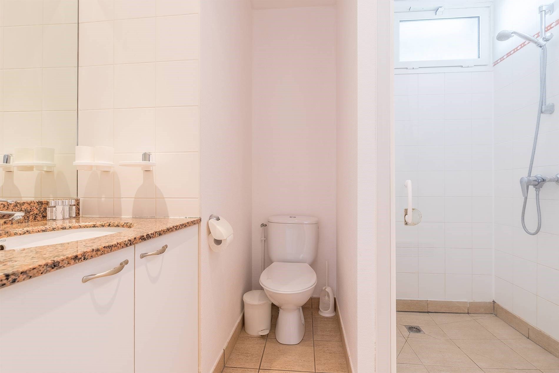 Ein Badezimmer mit Toilette, Waschbecken und Dusche.