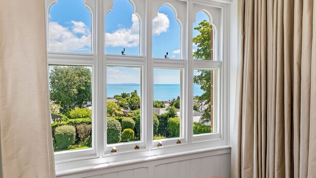 A room with a large bay window overlooking a coastal landscape. - Coedrath House - Luxury Manor, Swim Spa, Sea Views (Saundersfoot)