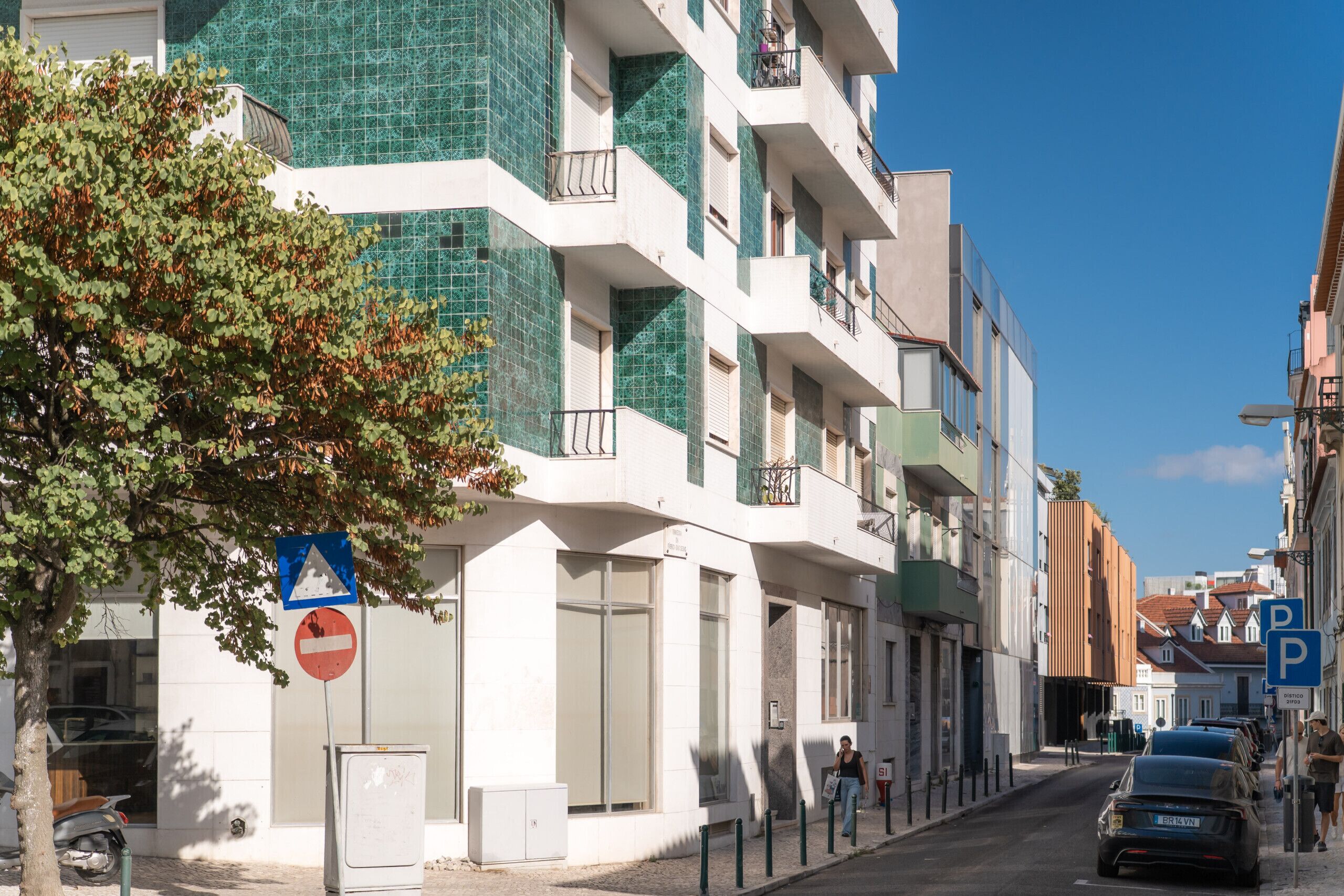 Een straat met moderne gebouwen, een verboden toegang-bord en een parkeerbord.