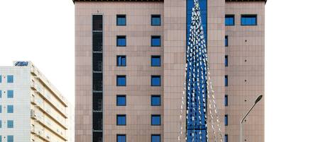 A hotel with a prominent tower featuring a vertical light display.