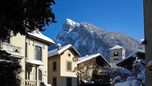 A snow-covered village with traditional architecture, a mountain in the background, and a clear sky. - Family friendly 3-bedroom apartment in Samoens close to ski bus and amenities (Samoëns)