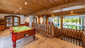 A wooden ceiling, a pool table, and a view of greenery. - Le Cristal Lognan7 Mountain View, Argentière (Chamonix), France (Argentière (Chamonix))