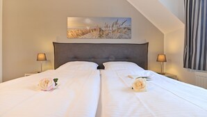 A double bed with two bedside tables, a headboard, and a painting above. - Haffblick Whg. Ha31, Germany (Ostseebad Boltenhagen)