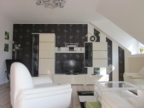 Flat-screen TV, books, stereo
