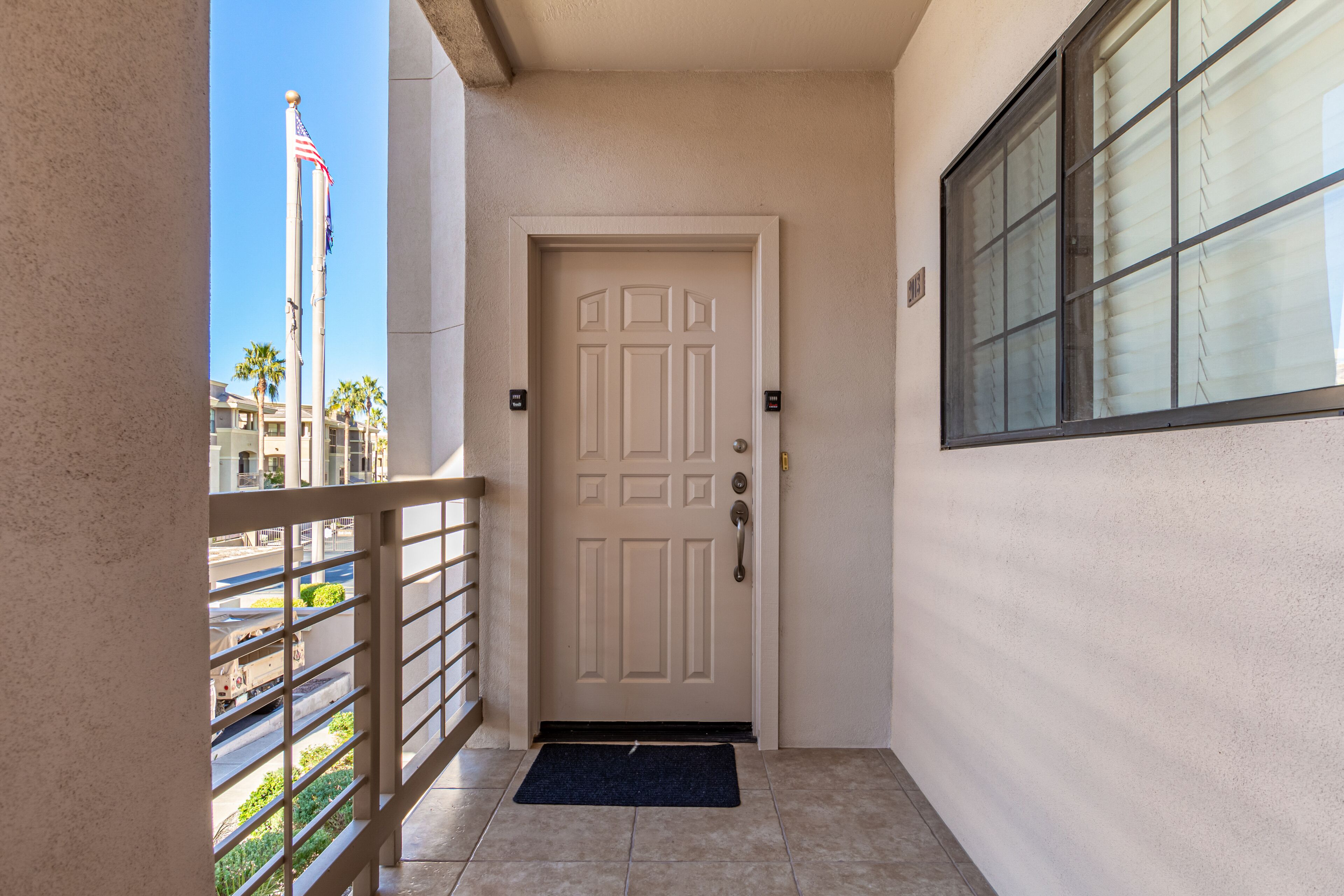 A white door with a doorknob and a mat at the entrance.