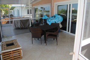 Enjoy meals al fresco in this patio area with a dining table and four chairs.