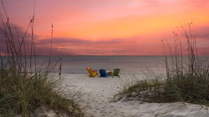 A beach scene with three beach chairs and a cooler on the sand. - Beachfront Property in Ocean Springs, Overlooking the Gulf of Mexico. Sleeps 14 (Ocean Springs)