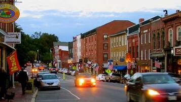 A street scene with buildings, cars, and pedestrians.