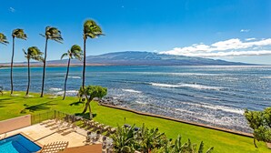 A poolside area with a view of the ocean and mountains. - Great Listing/Price/AC in the bedroom! (Maalaea)