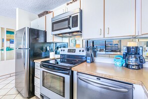Enjoy ocean views from the kitchen window while cooking with stainless steel appliances and a coffee maker.