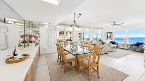 A spacious kitchen with a large island, modern appliances, and a view of the ocean. - 1856 - The Coastal Canvas: Serene Beachfront (Fernandina Beach)