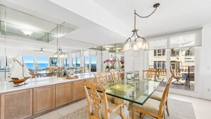 A spacious kitchen with a large island, modern appliances, and a view of the ocean. - 1856 - The Coastal Canvas: Serene Beachfront (Fernandina Beach)