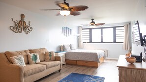 A bedroom with a bed, a sofa, a desk, and a ceiling fan. - The Captain and the Mermaid - Adventures in Paradise are waiting! (St Thomas)