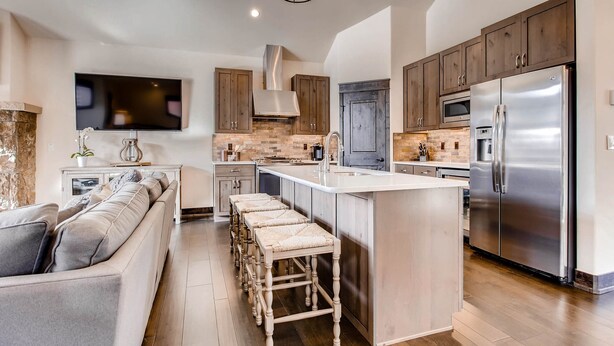 A modern kitchen with a central island, stainless steel appliances, and wooden cabinetry. - Keystone 4BR Townhome at River Run Base - Prices lowered for open dates! (Keystone)