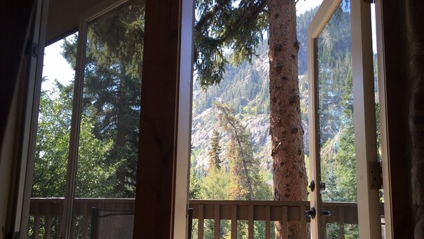A room with a large window overlooking a forested mountain area. - CREEKSIDE AND MOUNTAIN VIEW! Walk to Main St Frisco, Skiing, Pool, Trails (Frisco)