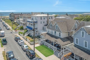 Stroll through a charming neighborhood with houses featuring balconies and porches, set amidst a scenic waterfront location.
