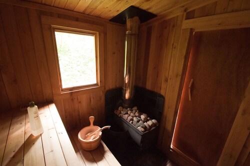 Mökki Hovland Hut - A Unique Glass Wall Timber Frame Nestled in a Maple Forest