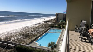 A balcony with a view of a beach and a swimming pool. - Luxury at it's finest! Penthouse unit overlooking the beautiful Gulf of Mexico! (Fort Walton Beach)