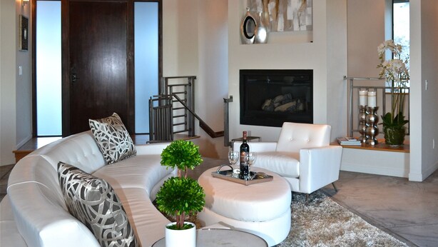 A modern living room with a sectional sofa, a round coffee table, and a fireplace. - Hilltop 365: Downtown Luxury ~ Stunning Views ~ Hilltop ~ 3 Blocks To Downtown  (Paso Robles)