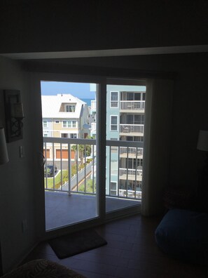 Enjoy the view of the city from the comfort of your room, with a sliding glass door leading to an outdoor area.