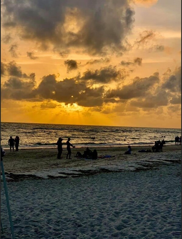 Enjoy a serene beach experience with gentle waves lapping at the shore.
