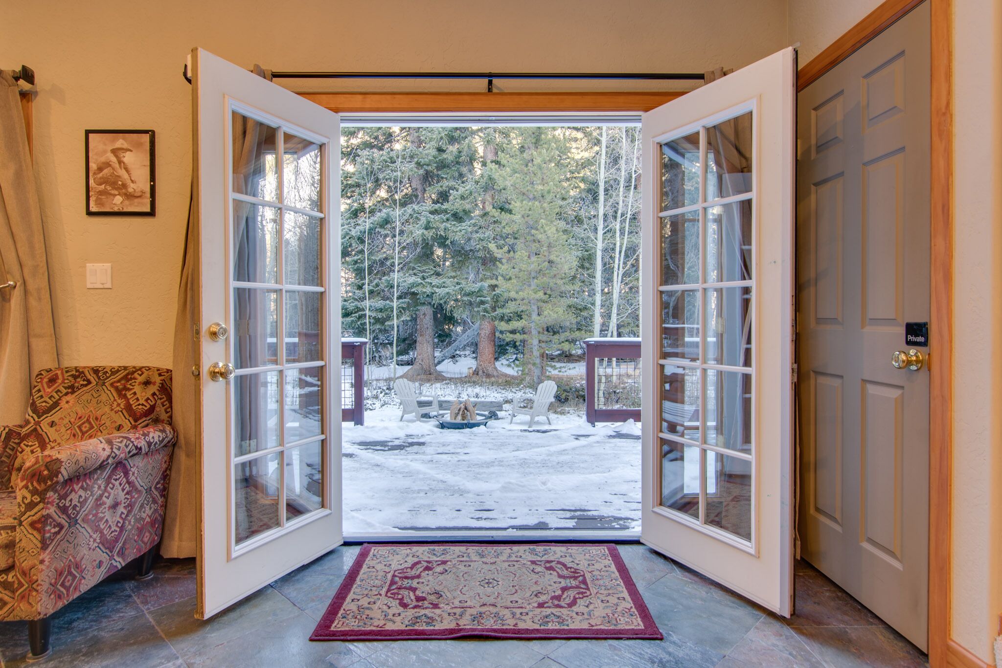 French doors invite you to outdoor decks, fire pit, and creekside seating