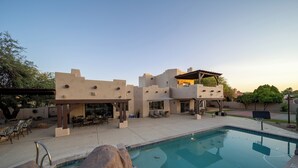 A modern poolside area with a pool, lounge chairs, and a covered patio. - Phoenix Scottsdale Golf House. NEW! Private Pickle Ball court. Great location. (Phoenix)