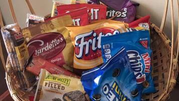 Ein Korb mit verschiedenen Snacks, darunter Chips, Kekse und Schokolade.