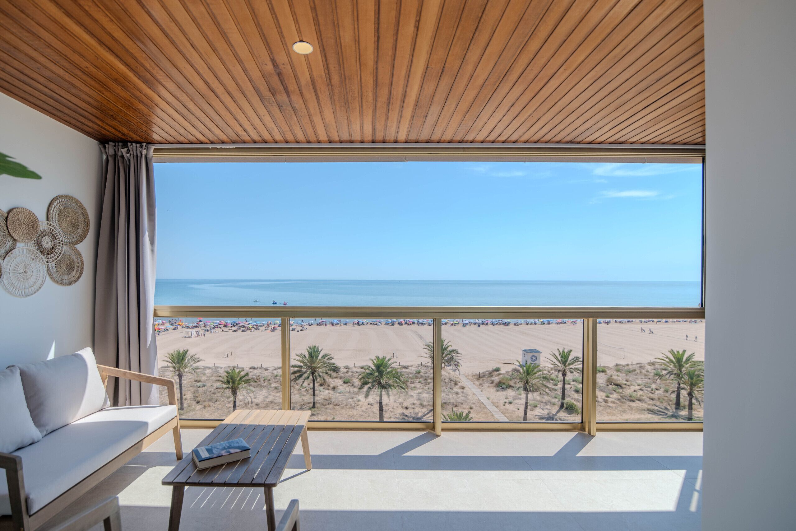 A balcony with a view of a beach and ocean.