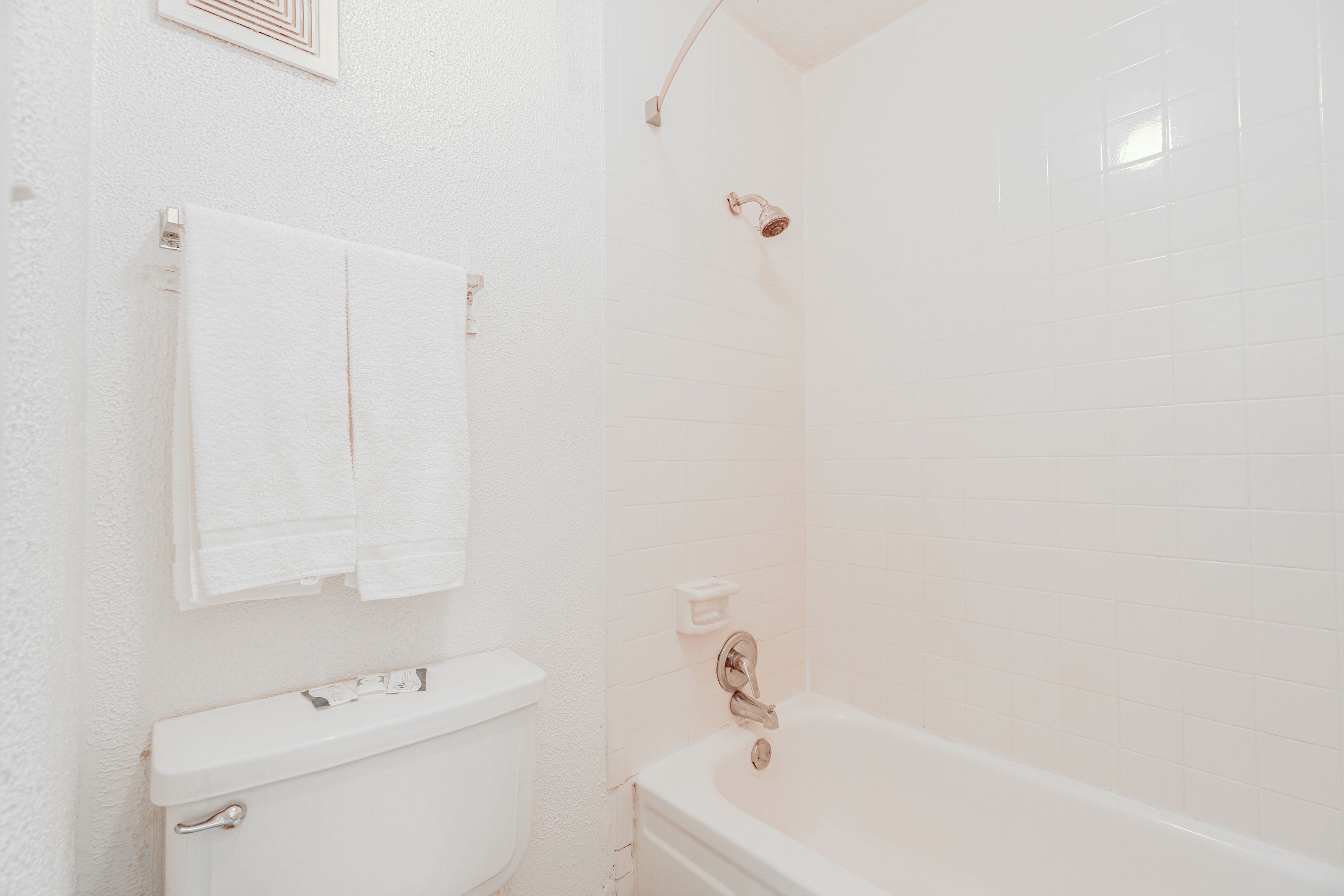 A bathroom with a toilet, sink, and bathtub.
