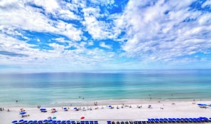 A beach with clear skies and calm waters. - Steps to the Sand at our Beachfront Condo at Majestic, 5th floor convenience  (Panama City Beach)