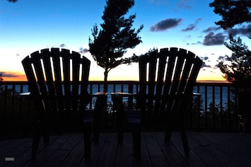 Chairs on the front deck on a bluebird day.