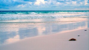 A beach with waves, a clear sky, and a sandy shore. - Steps to the beach and restaurants!!! (St. Augustine)