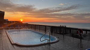 A swimming pool on a deck with a sunset view. - Beautiful 6BR Gulf Front Home - "REST AREA WEST" - Pool & Deck - Reserve Now! (Gulf Shores)