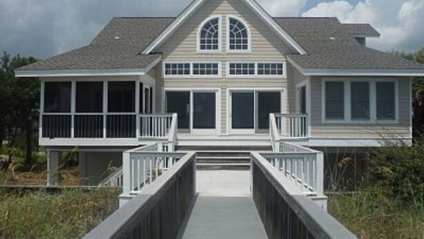 A two-story house with a covered walkway leading to the entrance. - 476 Tarpon - Ocean Front - Full Time Beach (Fripp Island)
