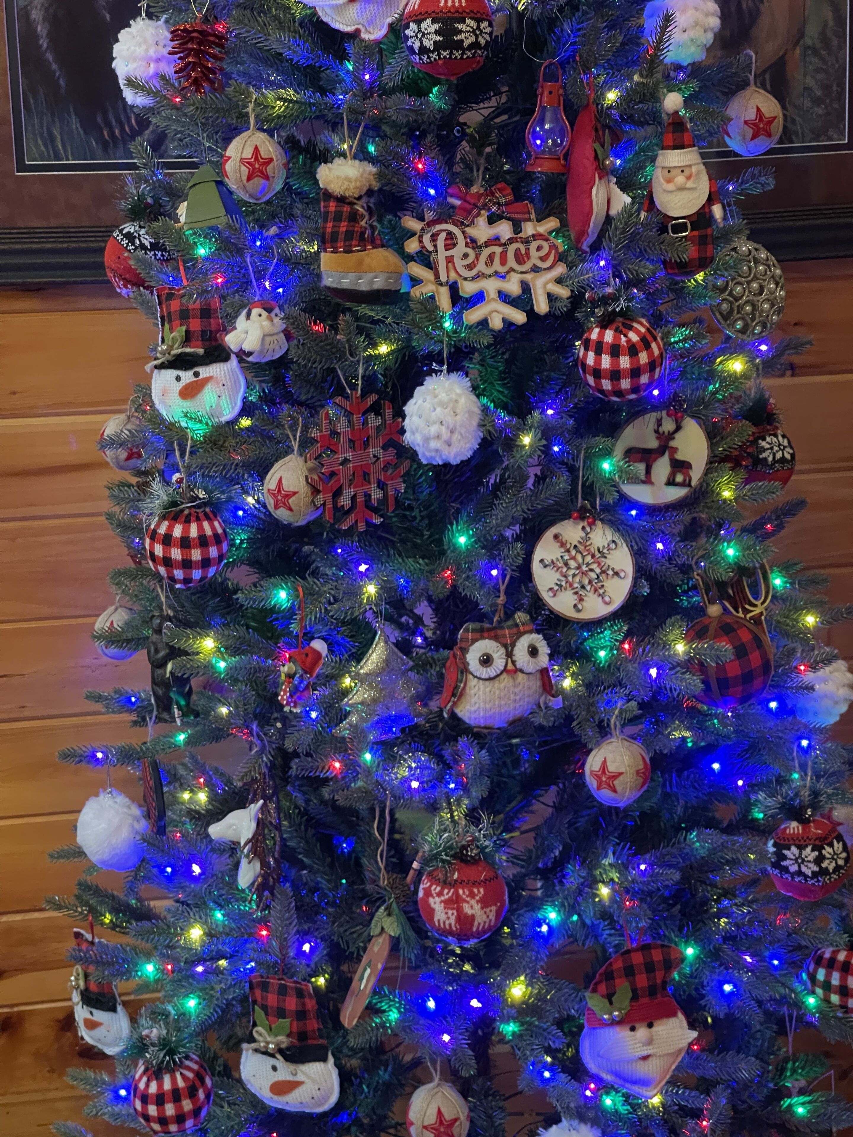 A Christmas tree with various ornaments and lights.