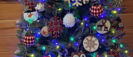 A Christmas tree with various ornaments and lights.