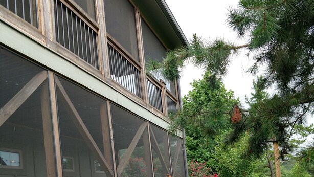 A modern building with large windows and a balcony.