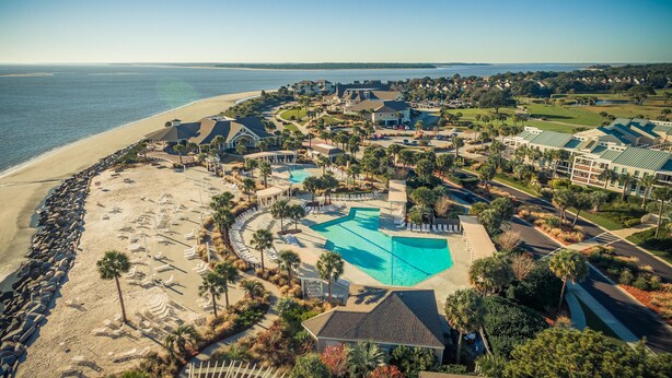 A resort with a large pool, beach access, and a golf course.