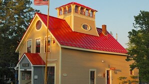A two-story building with a red roof and beige siding. - Harbor/🦞 Pound Access & Views from Large Deck (Owls Head)