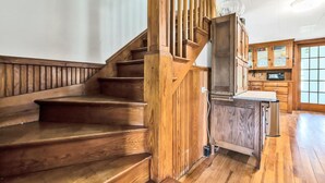 A wooden staircase with a glass door leading to a kitchen area. - Harbor/🦞 Pound Access & Views from Large Deck (Owls Head)