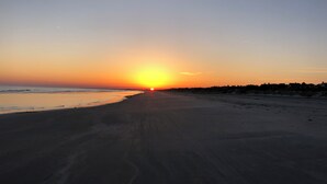 A beach at sunset with a clear sky and a visible horizon. - Gorgeous Home 5 minute walk to beach (Kiawah Island)